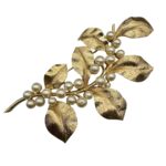 Large Trifari gold tone and faux pearl brooch.