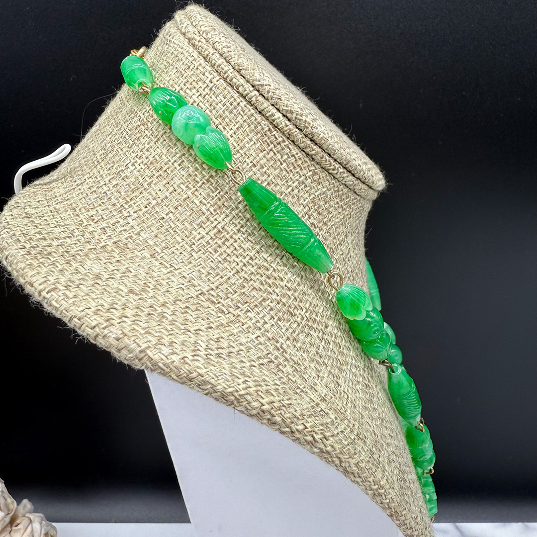 Green faux jade plastic necklace side view.