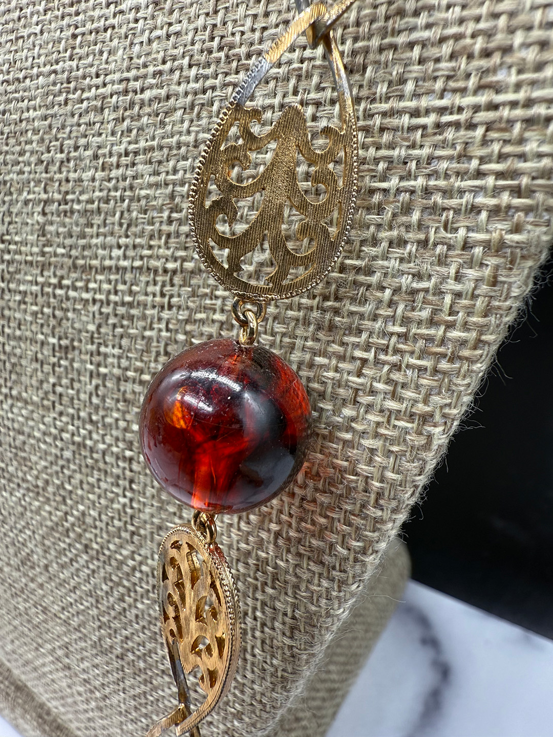 Amber-colored Lucite station necklace metal wear.