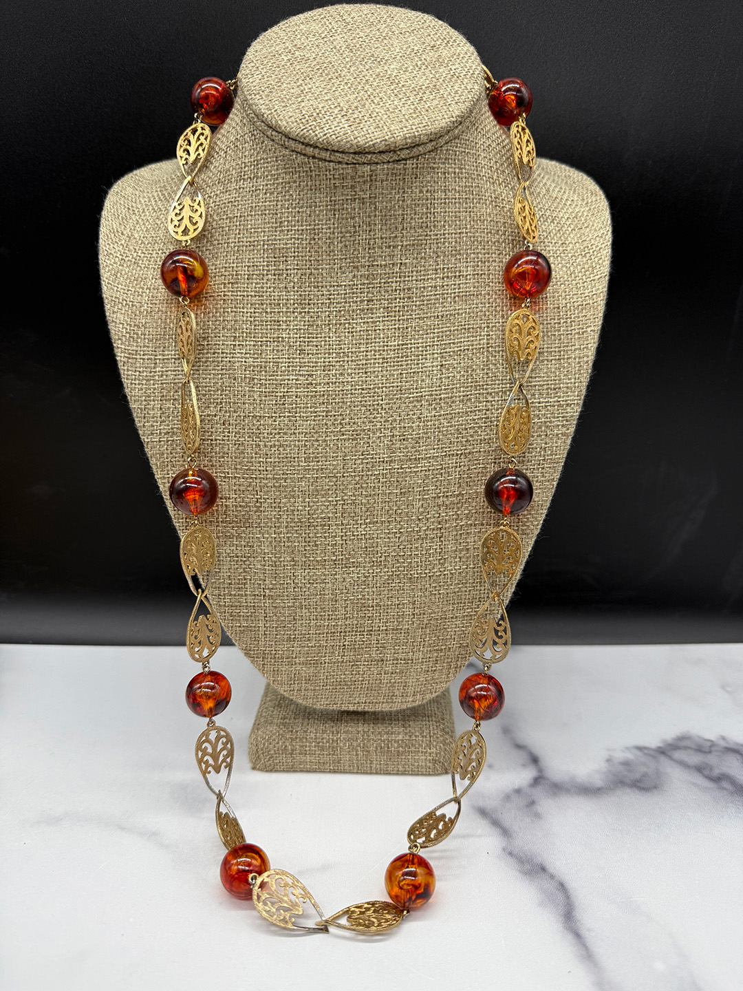 Amber-colored Lucite station necklace.