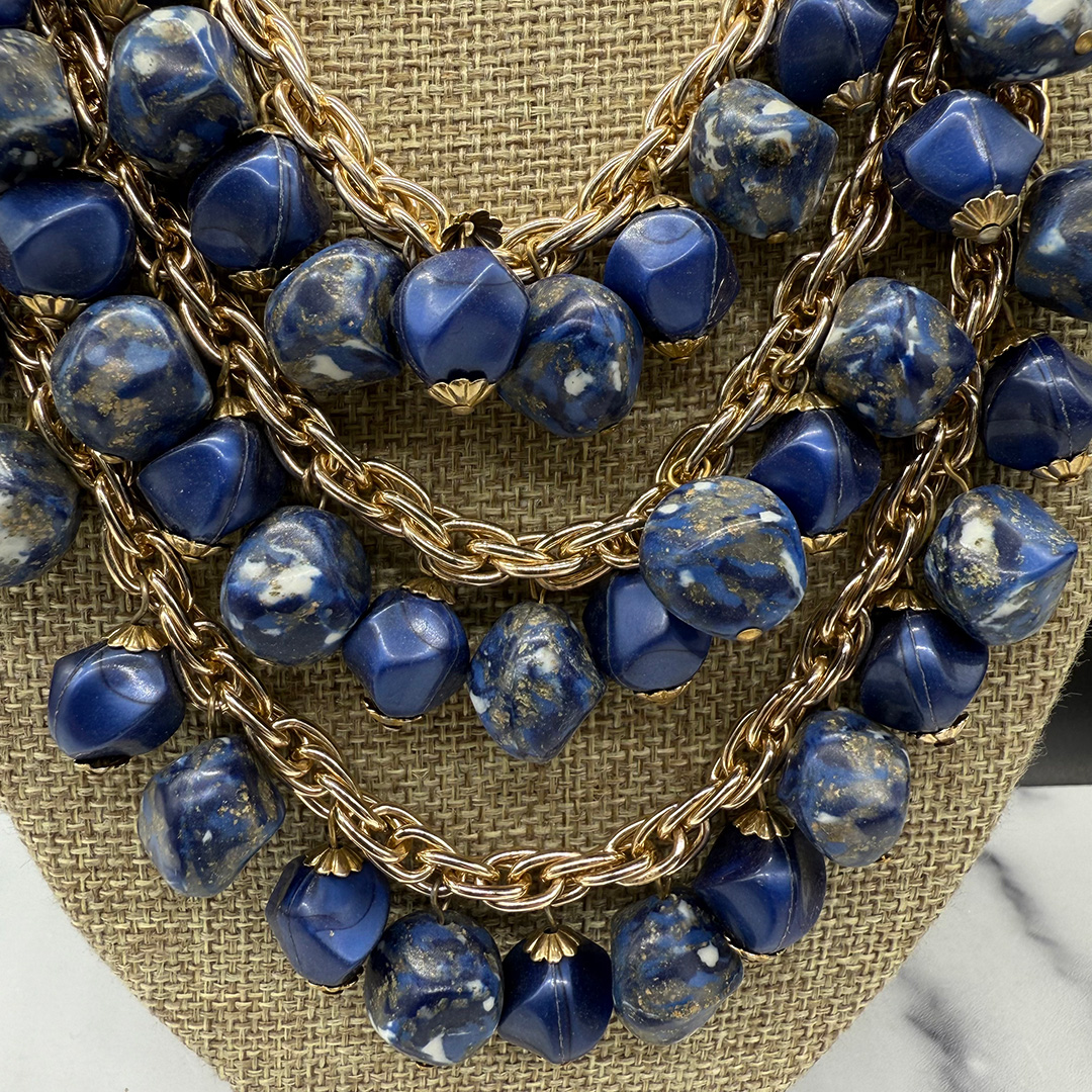 Coro triple-strand bead bib necklace.