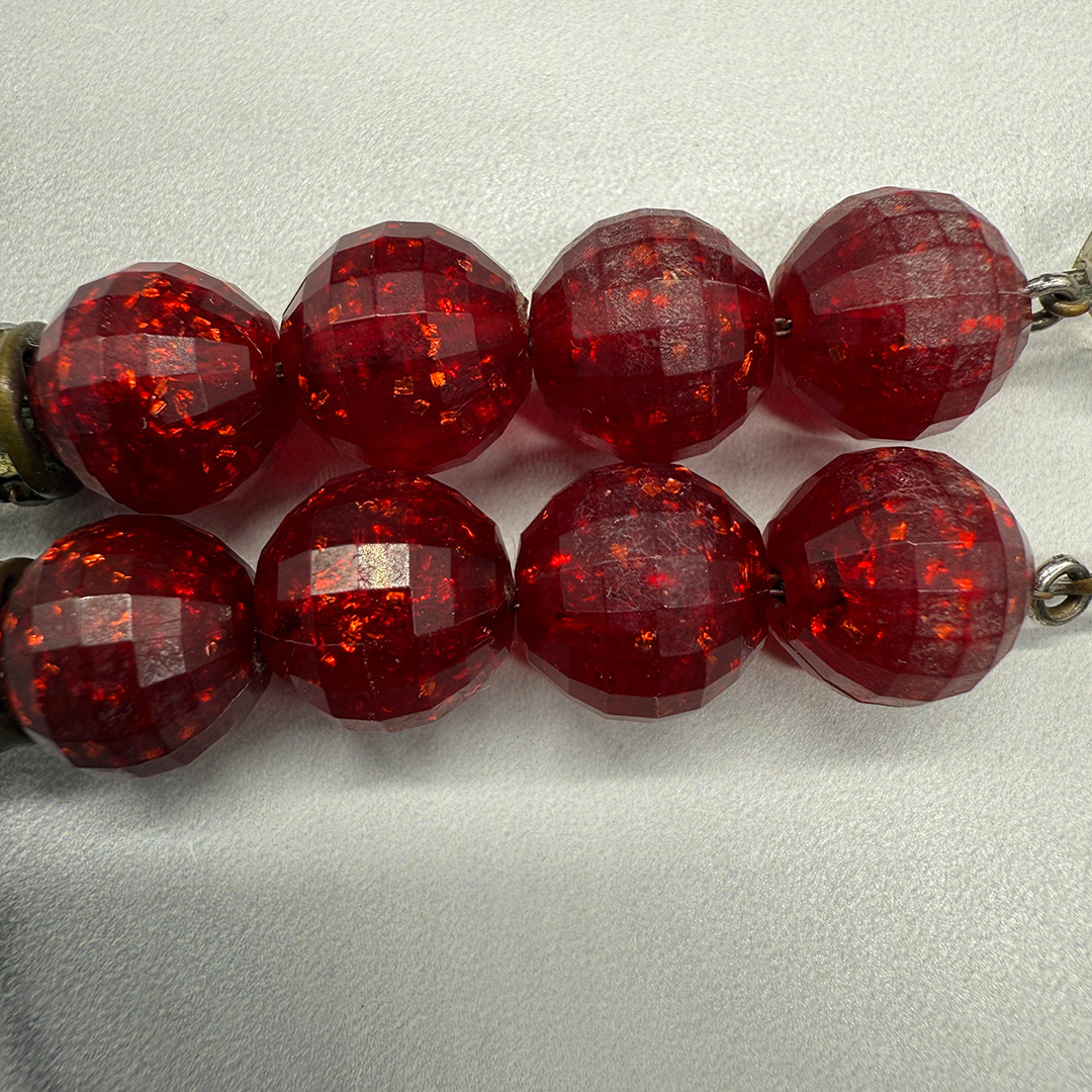 Hobe red resin bead surface wear.