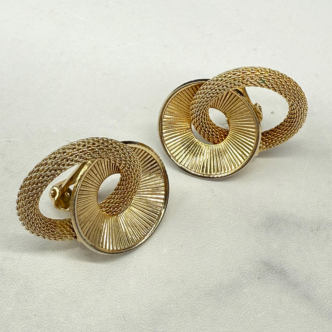 Kramer gold tone clip back earrings.