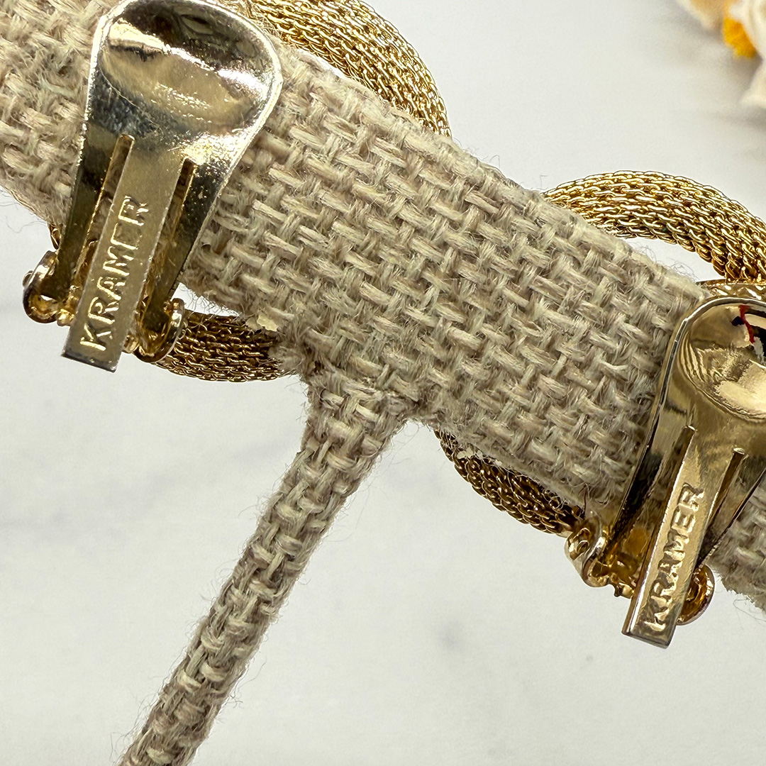 Kramer gold tone clip back earrings.