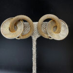 Kramer gold tone clip back earrings.