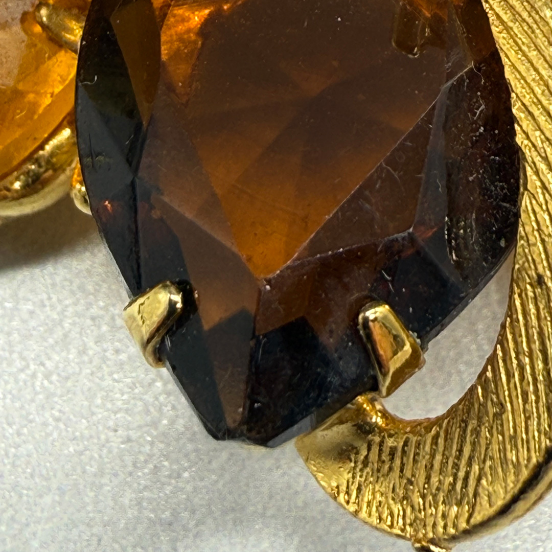 Wonderful amber-colored rhinestone brooch.