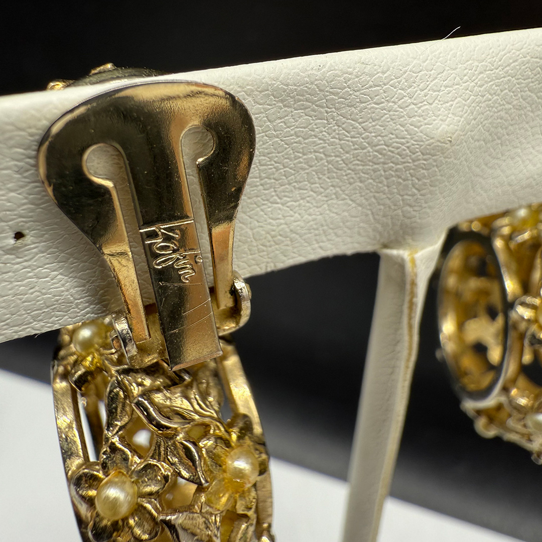 Kafin open metalwork floral drop earrings.