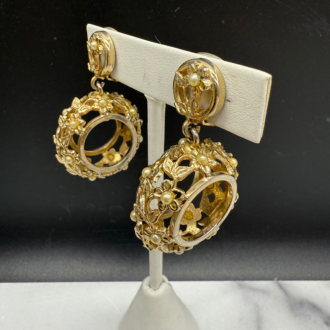 Kafin open metalwork floral drop earrings.