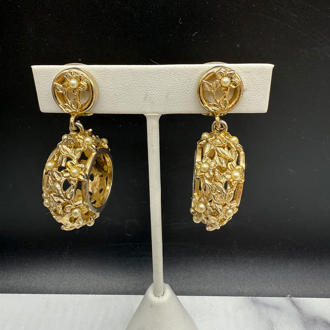 Kafin open metalwork floral drop earrings.